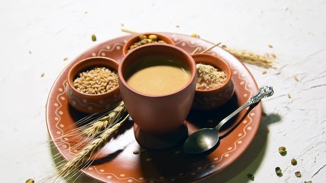Sattu sharbat is a cooling sweet drink made in summer with roasted black chickpea flour, barley, suger, salt & water. served in a glass. selective focus