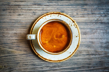 Cup of coffee on a wooden table. Copy space.