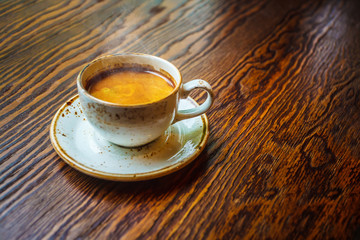 Cup of coffee on a wooden table. Copy space.