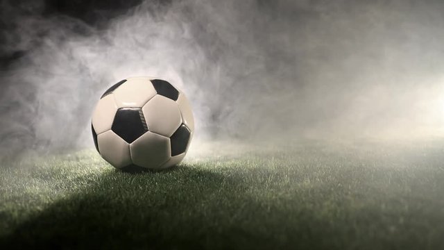 Ball stand in grass around smoke and fog