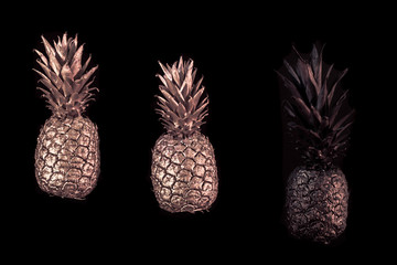 Golden pineapple on black isolated background creative and art © puhimec