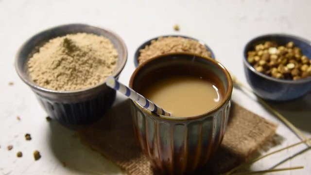 Sattu sharbat is a cooling sweet drink made in summer with roasted black chickpea flour, barley, suger, salt & water. served in a glass. selective focus