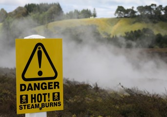 Yellow warning sign for hot steam burns at Orakei Korako Thermal Area, New Zealand