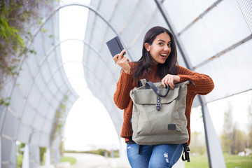 Excited mixed race girl found notebook in handbag