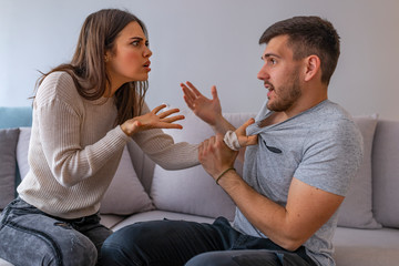 Couple Having Argument At Home . Furious couple arguing while having problems in their relationship. Couple conflict. Don't you have ANYTHING to say?!