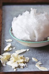 Coconut oil on the plate on the grey background