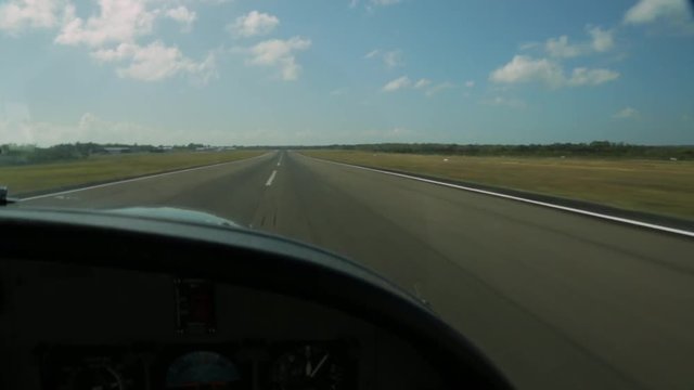wide still shot from a cockpit of plane landing at Lady Elliot Island's tarmac ked runway strip, Great Barrier Reef