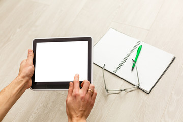 Digital tablet computer with isolated screen in male hands background