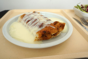 Delicious apple strudel with custard and fruit salad in a canteen in Germany