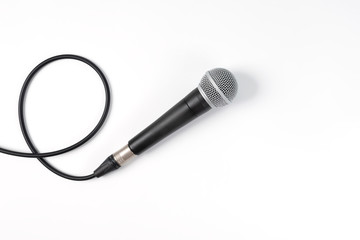 Microphone on white background with clipping path . Close up of dynamic microphone connect with male xlr connector and  cable isolated on white background,top view. - obrazy, fototapety, plakaty