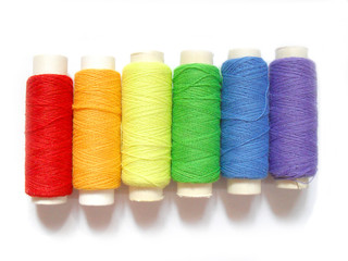 colorful bobbins isolated on white background, rainbow colors