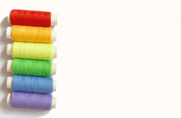 colorful bobbins isolated on white background, rainbow colors