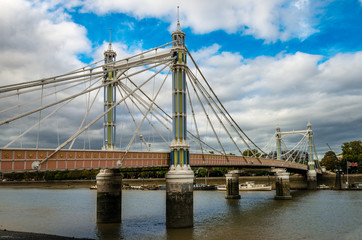 Albert Bridge in London, UK. Its a road bridge over River Thames connecting Chelsea in Central London on the north, left bank to Battersea in South/South-West London. 
