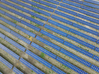 Aerial view of a solar farm producing clean renewable sun energy, industrial landscape
