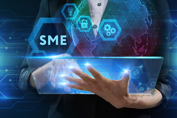 The concept of business, technology, the Internet and the network. A young entrepreneur working on a virtual screen of the future and sees the inscription: SME
