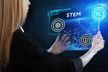 The concept of business, technology, the Internet and the network. A young entrepreneur working on a virtual screen of the future and sees the inscription: STEM