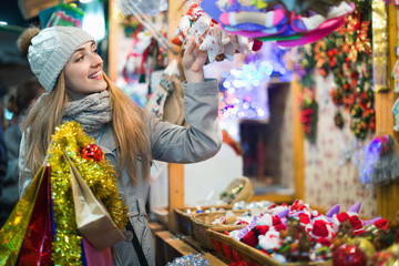 Young woman at fair near counter with Christmas gifts