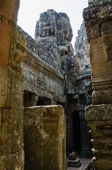 Fototapeta premium Smiling Faces of Bayon Temple in Angkor Thom is The Heritage of Khmer Empire at Siem Reap Province, Cambodia.