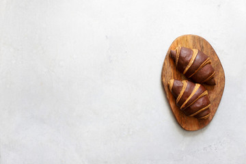 Croissants with chocolate on a wooden Board top view