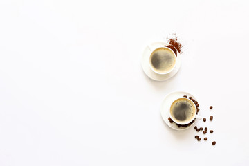 Two cups of espresso . Coffee beans, ground coffee on white background