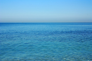 Fototapeta na wymiar Blue surface of the calm sea