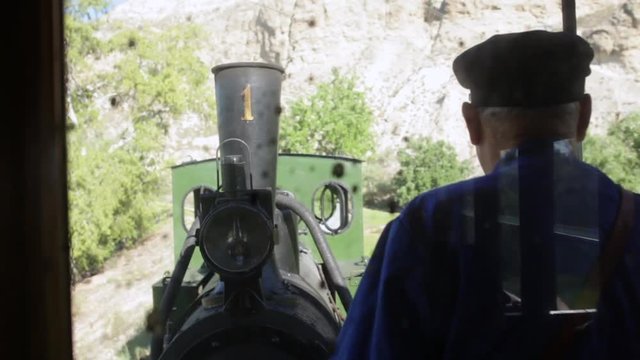 view from the vagon of the steam engine and the conductor in an old steam train