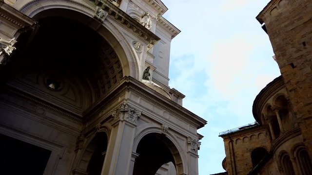 Bergamo, Italy. March 21, 2019 - 4k video Pano, dolly or slider move from left to right from the Roman Catholic Diocese of Bergamo to Basilica of Santa Maria Maggiore Cappella Colleoni, Citta Alta 