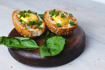 Bun with egg, Whole grain mustard and fresh basil  on the wooden background