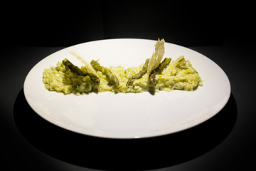 Risotto with asparagus decorated with cheese waffle