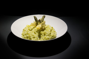 Risotto with asparagus decorated with cheese waffle