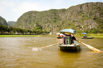 ninh bin tourist traveling through river with rowing boats - 265486403
