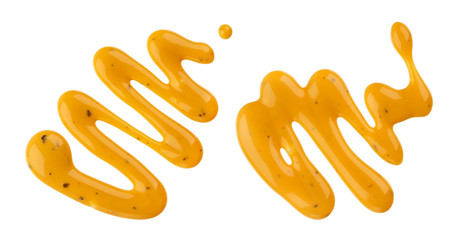 Mustard sauce, splash of honey mustard salad dressing isolated on white background