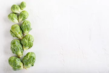 Gordijnen Fresh raw organic brussels sprouts on white background. Top view, flat lay, copy space. © geshas