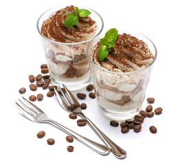two portions Classic tiramisu dessert in a glass isolated on a white background