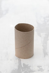 Empty toilet paper on gray ceramic background