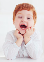 sincere head portrait of happy redhead toddler baby boy