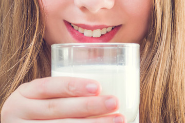 young woman with glass of milk