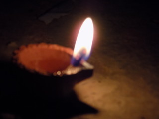 burning candle on black background