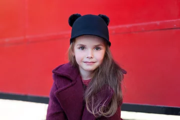 Foto op Plexiglas Klein vrolijk meisje in de buurt van de rode Engelse bus in een mooie jas en hoed. Klein vrolijk meisje in de buurt van de rode Engelse bus in een mooie jas en een hoed. De reis van het kind. Schoolbus. Londen rode bus. © stock_studio