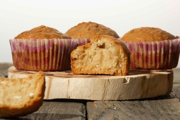 homemade muffins with coconut chips on a wooden stand