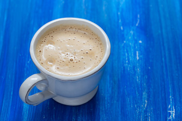 a cup of coffee on old wooden background