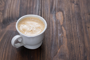 a cup of coffee on old wooden background