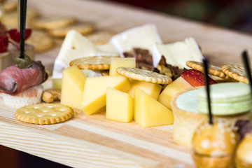 Cheese plate close-up with several varieties of fruit and honey cheese.