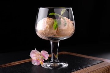 Ice cream dessert in a glass on a dark background.