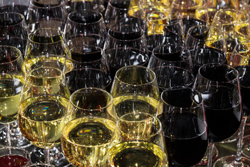 Rows of glasses full of wine at a romantic banquet at a nightclub close-up shot.