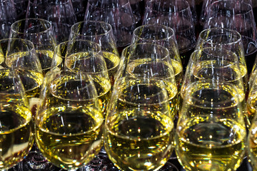 Rows of glasses full of wine at a romantic banquet at a nightclub close-up shot.