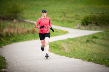 Fit senior woman in 50s exercising and keeping fit by running in a park