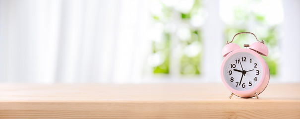 Alarm clock on table by the window