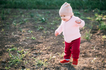 little girl one year playing in the village outdoors