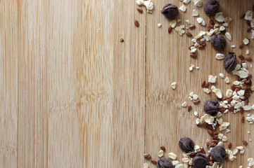 Oats, flax seeds and chocolate chips  seeds on wooden table with copy space